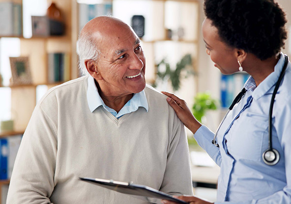A doctor talks to her patient and comforts him